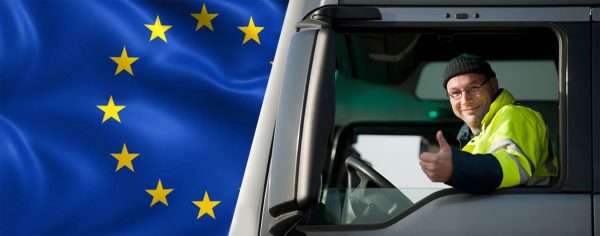 Водитель в кабине на фоне флага ЕС